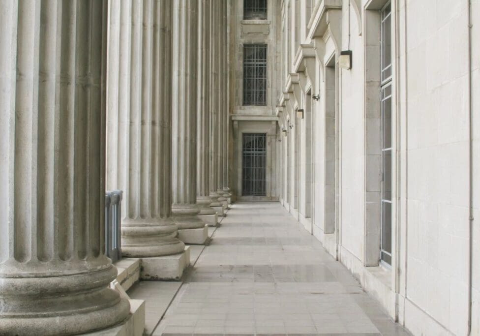 A row of pillars in the middle of an alley.